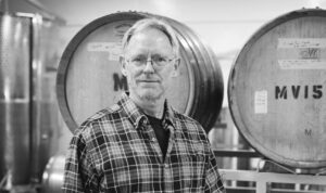 Steve standing in front of barrels