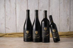 Cobble Hill wine bottles lined against a wall